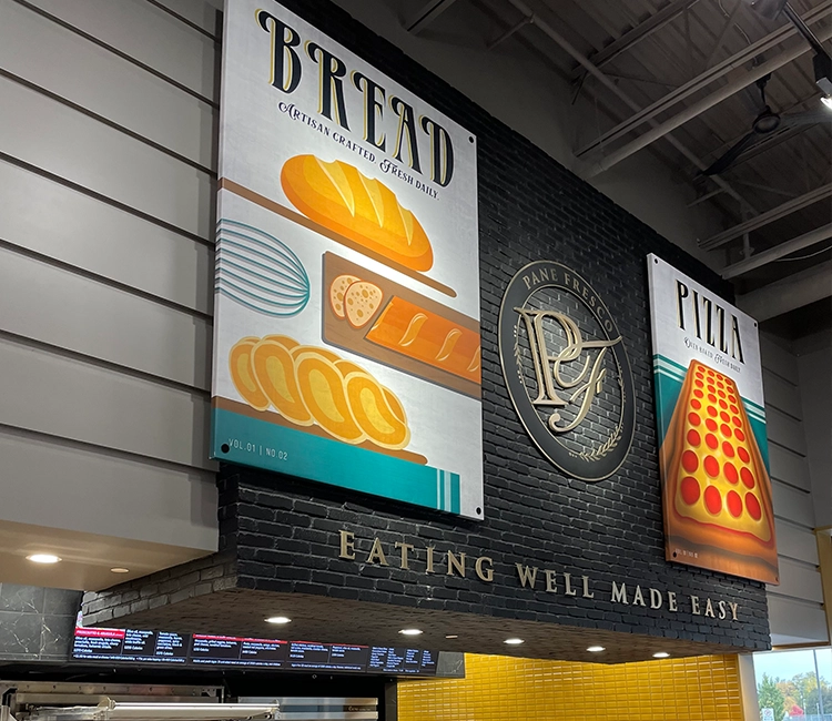 Colorful signage for "Bread" and "Pizza," showcasing artisan baked goods, with a decorative logo and the tagline "Eating Well Made Easy."